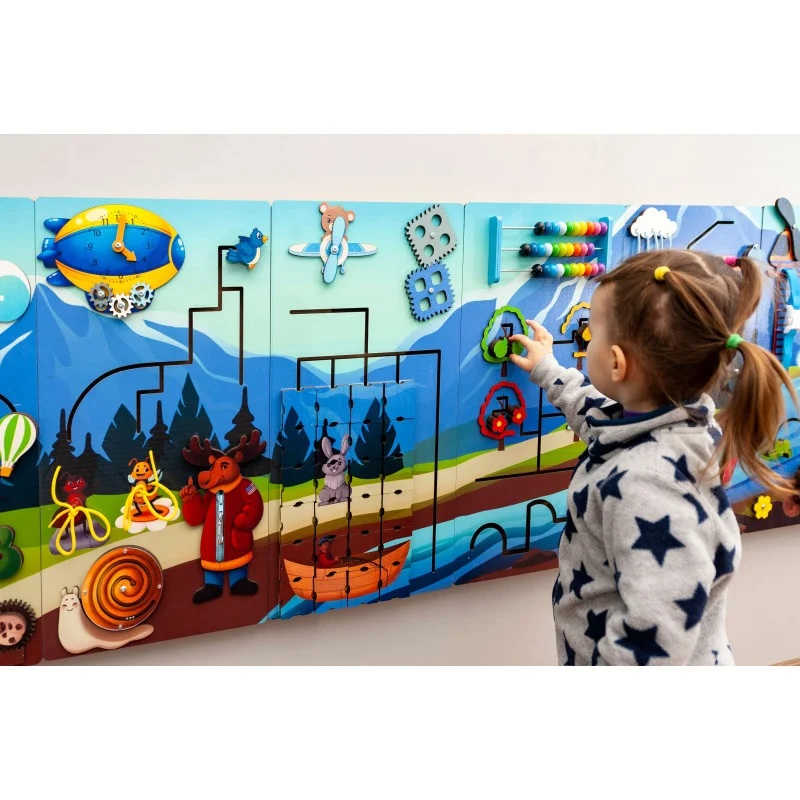 Extra Large Mountain Themed Busy Board Wall panel with a girl playin g