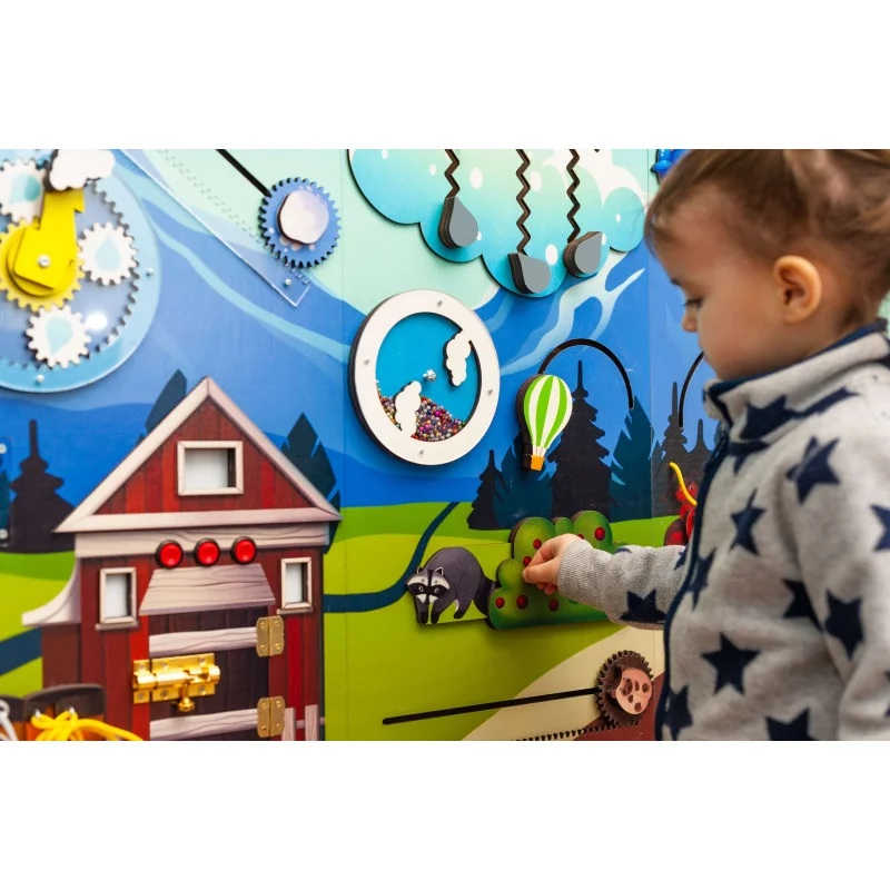 Mountain themed busy board sensory wall panel with a girl playing 