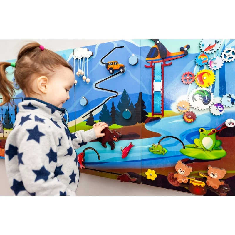 Mountain Themed Sensory wall panel busy board with a girl playing