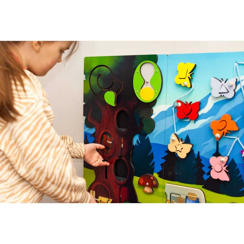 Extra Large Mountain Themed Busy board sensory wall with a girl playing