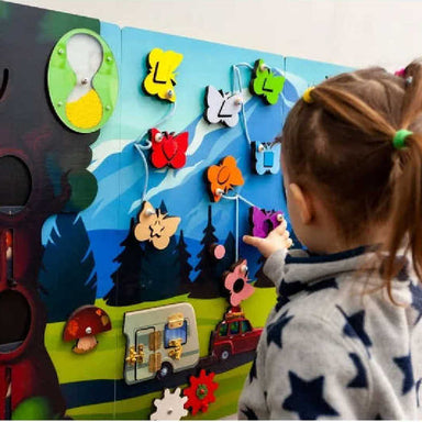 Kid playing with a sensory busy board
