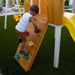 Forest - Modern Backyard Outdoor Swing Set with a boy climbing on the rock wall