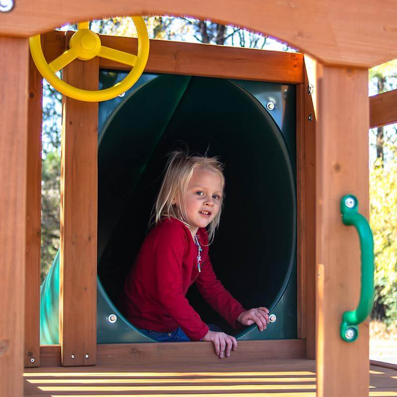 Child entering tube slide on Gorilla Outing swing set