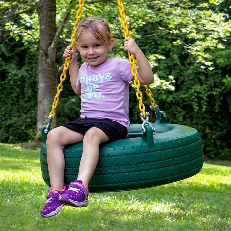 Gorilla Playsets Pioneer Peak Swing Set A Kid Sitting on A Tire Swing