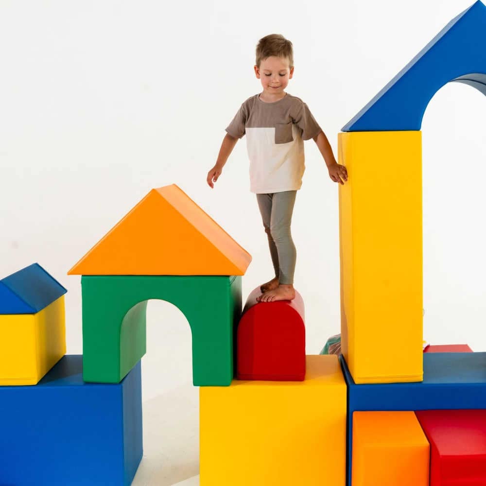 iglu soft play set castle in multicolors with boy climbing