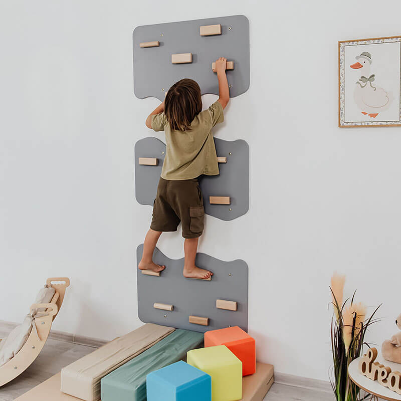 Indoor Rock Climbing Wall for Home With Cloud Shaped Panels Wooden Climbing Holds for Kids 3 10 Tone Gray Set of 3 Side View Boy