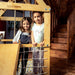 Indoor Wooden Playhouse with Triangle ladder, Slide Board and Swings with girls playing inside