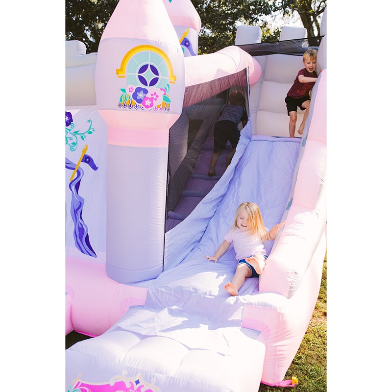 kid-sliding-on-kid-wise-princess-enchanted-castle-with-slide-bounce-house-up-close