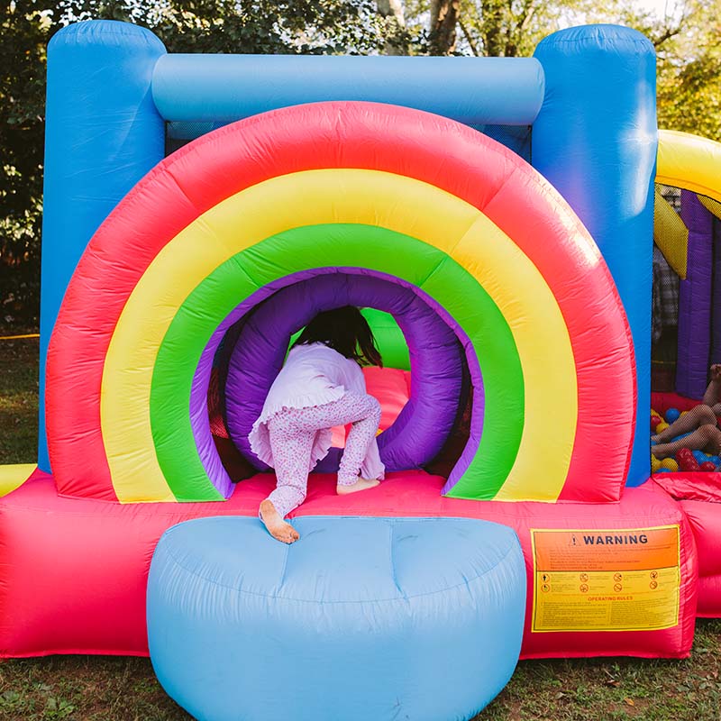 kid-wise-lucky-rainbow-bounce-house-kid-in-pink-crawling