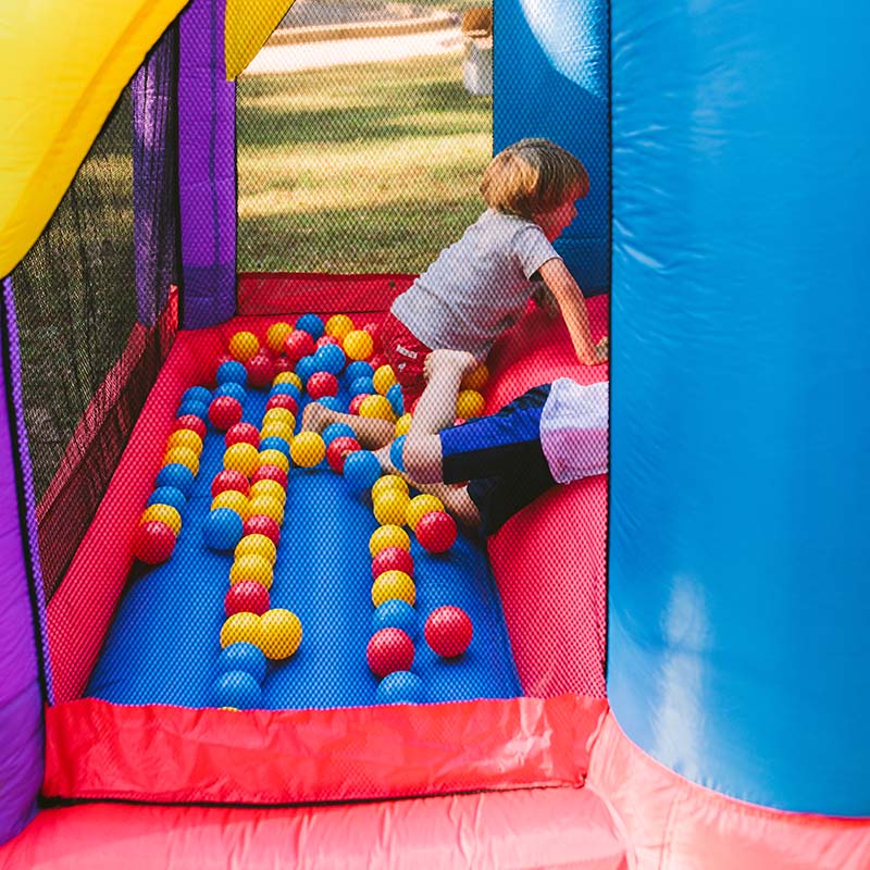 kid-wise-lucky-rainbow-bounce-house-kids-play-at-the-ball-pit