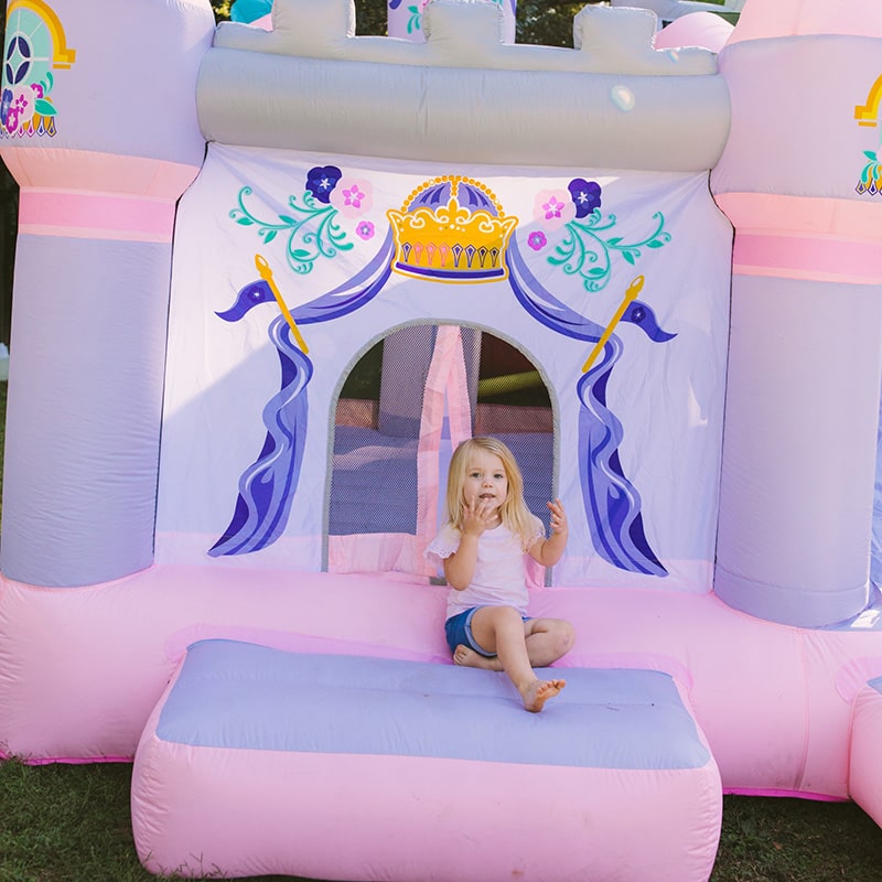 kid-wise-princess-enchanted-castle-with-slide-bounce-house-front-view-kid-sliding