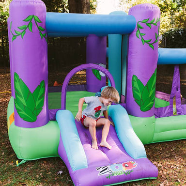 kid-wise-zoo-park-inflatable-bounce-house-with-ball-pit-front-view-with-kid-sliding