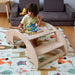 Kidodido 2 In1 Montessori Wooden Seesaw and Table Chair Set Showing A Kid playing A Wodden Animal Puzzles