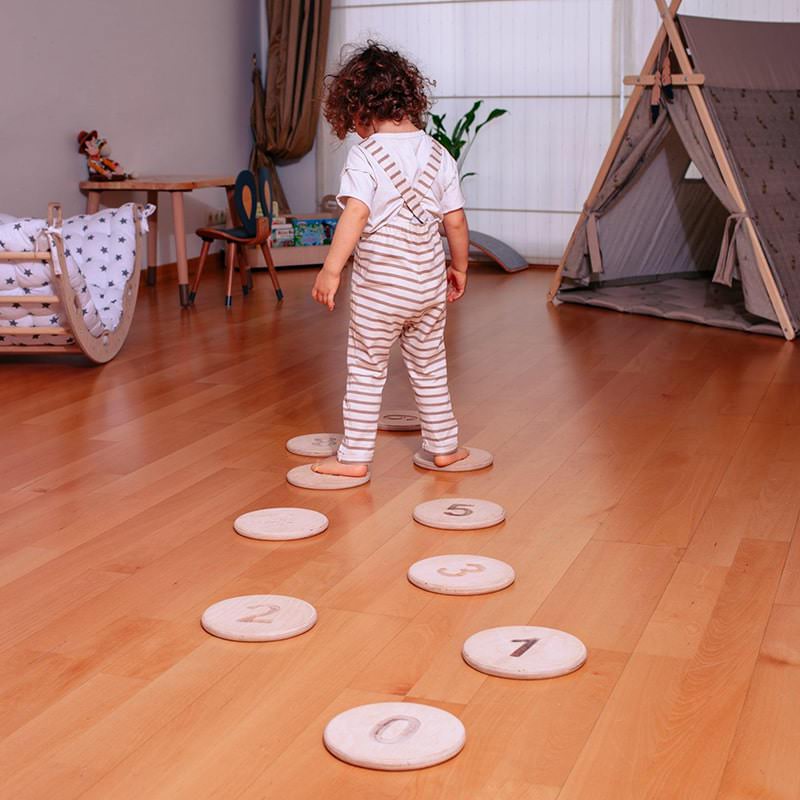 Kidodido Balance Beam and Stepping Stones Set A Kid Standing On Stepping Stones