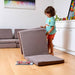 Kidodido Transformable Kids Play Mat and Couch - Multipurpose Baby Play Mat and Kids Couch Brown Showing A Kid Folding The Mat