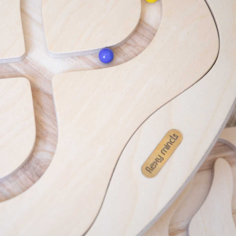 Close-up of the wooden Loomi Wobble Board and maze surface
