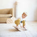 Young boy using the Loomi Wobble Board for indoor balance play