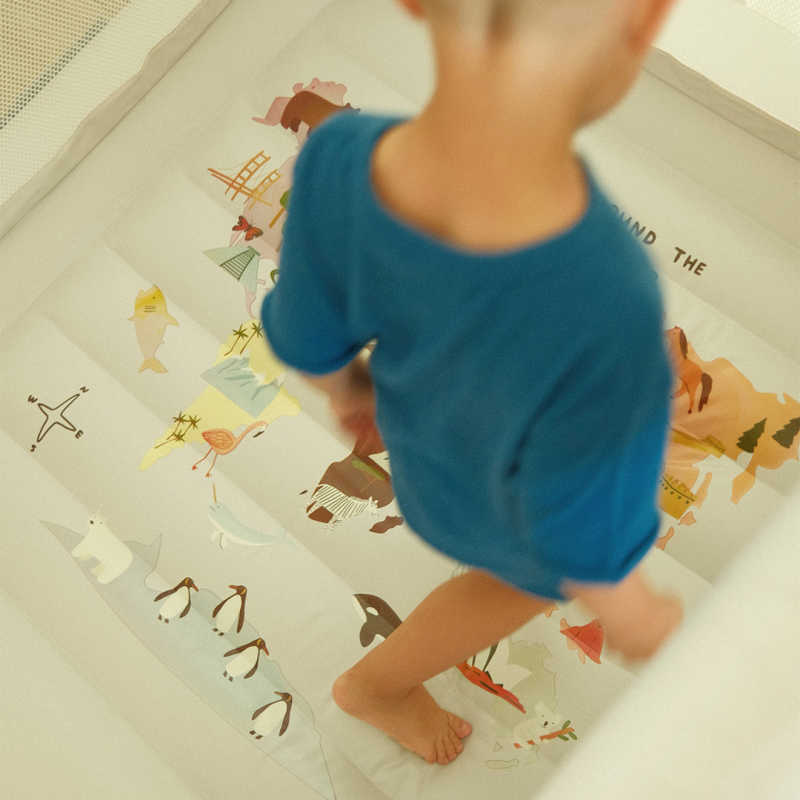 Mini World Map Inside Bounce House top view of floor with boy