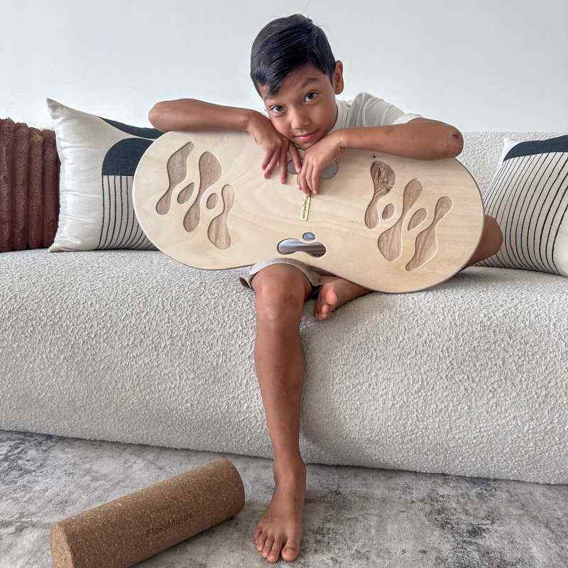 Young boy using the Orrin Balance Board for indoor balance practice