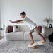 Boy practicing balance on the Orrin Balance Board with cork roller