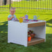 oudoor sensory play table for water, sand and nature materials with girl playing
