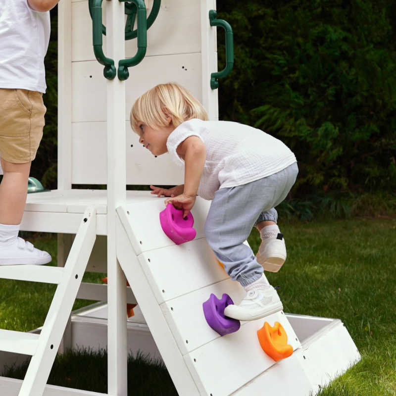 Outdoor water play for toddlers with boy climibing