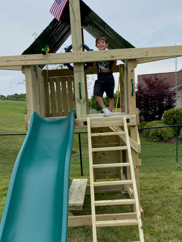 Pathfinder Swing Set: Space Saver Edition with a boy in the fort