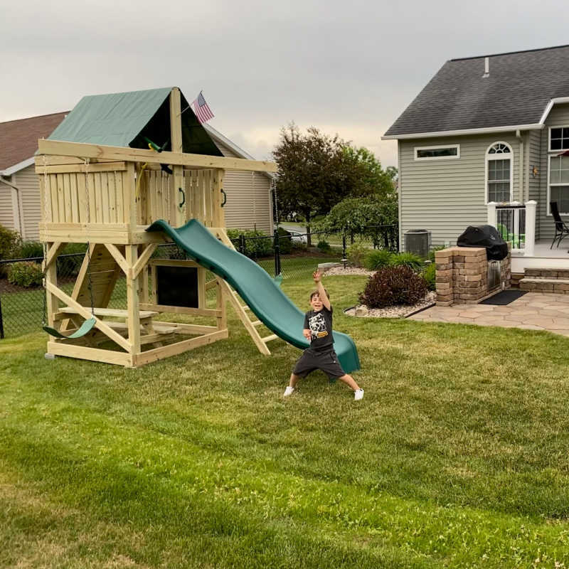 Pathfinder Swing Set: Space Saver Edition with a boy in the backyard