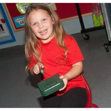 Playmore Design Eco Percussion Set With Box and Sorter Playing a Green Percussion Instrument