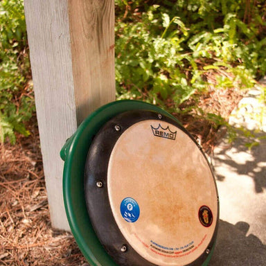 Playmore Design Single Play Drum Table Playground Musical Equipment Drum Mounted on a Green Circular Frame Outdoors