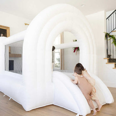 Rainbow Neutral Bounce House with 2 kids playing inside