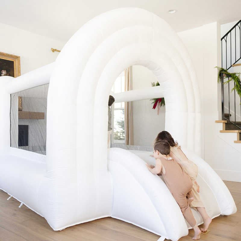 Rainbow Neutral Bounce House with 2 kids playing inside