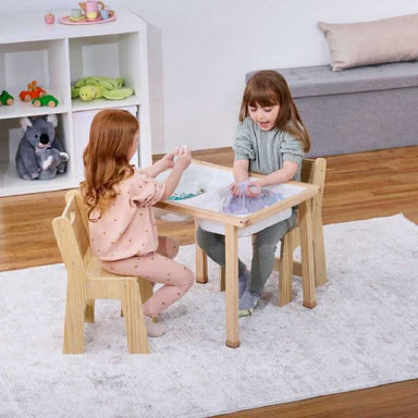 Sensory activity table with 2 girls playing with sand
