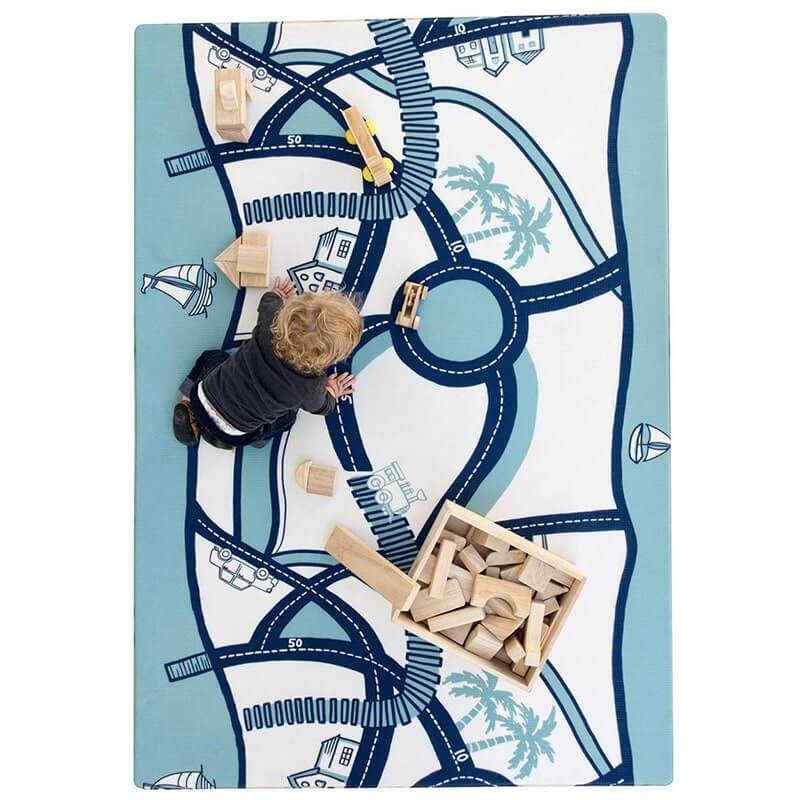 Shwally August Rose White Reversible Playmat with a toddler playing with blocks
