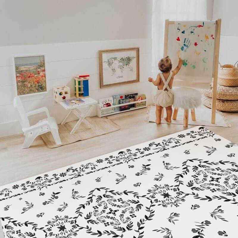 Shwally August Rose White Reversible Playmat with a toddler drawing in a playroom