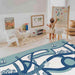 Shwally August Rose White Reversible Playmat with a toddler in a playroom