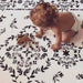 Shwally August Rose White Reversible Playmat with a baby on the  black and white side