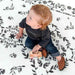 Shwally August Rose White Reversible Playmat with a toddler playing with a car