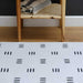 Shwally Remi Play Mat in black and white pattern in a living room