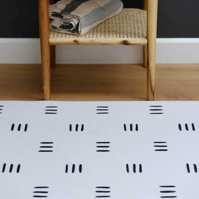 Shwally Remi Play Mat in black and white pattern in a living room
