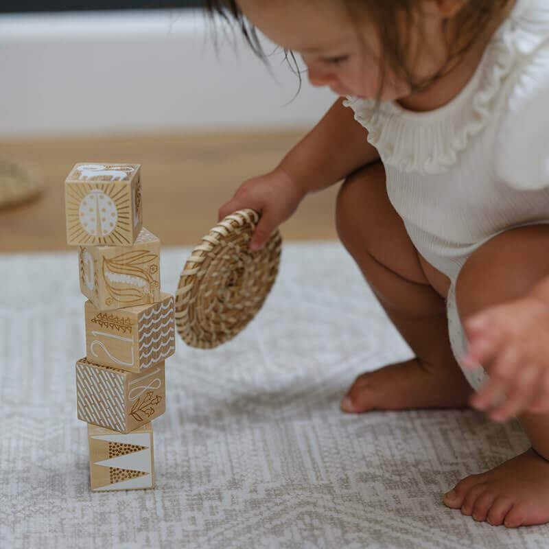 Shwally Remi Play Mat with a baby playing on it with blocks