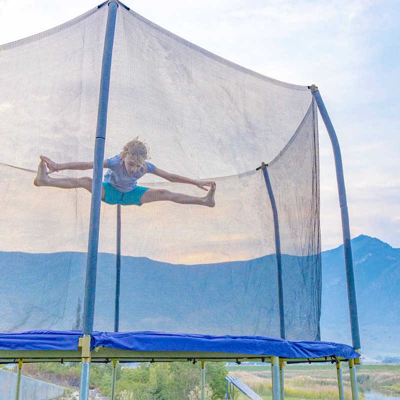 Skywalker Trampolines 12' Round Trampoline with kid jumping 
