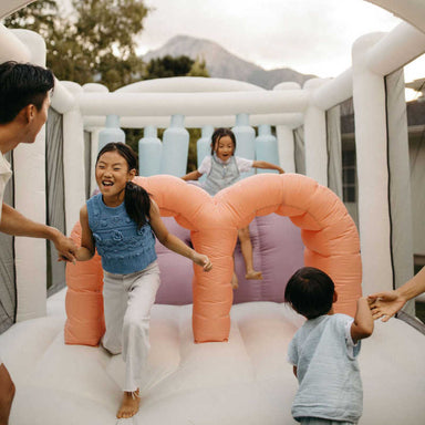 Smol Course Bounce House with kids inside it playing 
