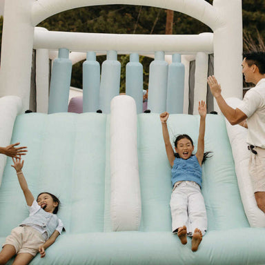 Smol Course Bounce House with girls sliding 