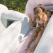 Smol Market Splash Bounce House with kids going down a slide with water