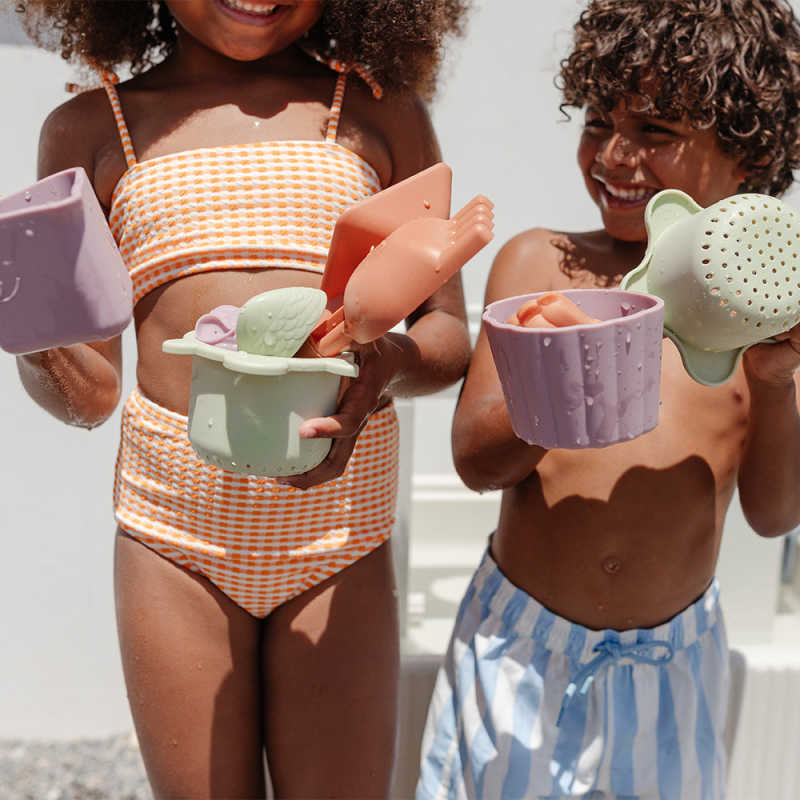 Smol Tide Water & Sensory Table with kids holding accessories