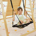 Boy using the rope swing on the Avenlur Sweetgum XL indoor sensory playset