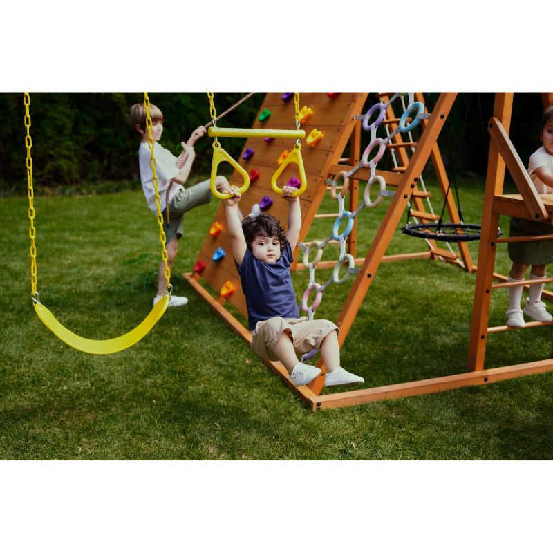 Sycamore Swing Set and Outdoor Climber with boy on trapeeze