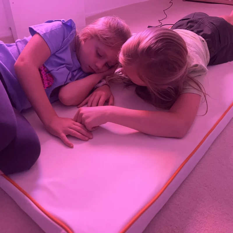 Two kids using TFH Vibrating Floor Pad - Long in sensory space