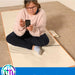 TFH Vibrating Floor Pad - Long with child resting on sensory vibration mat